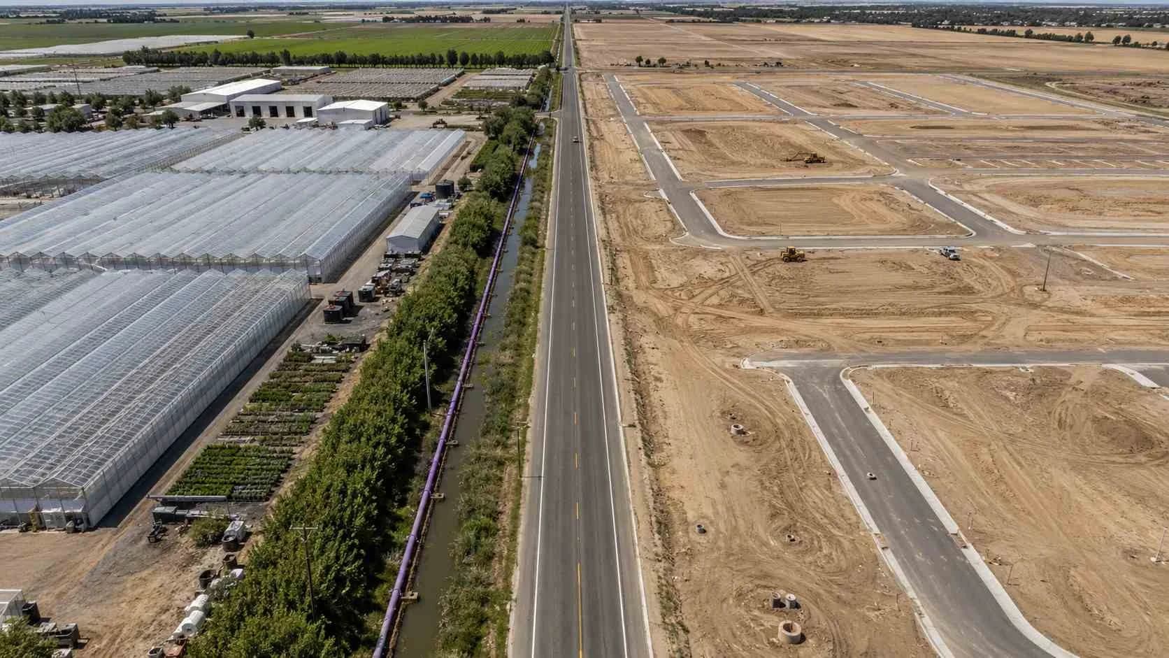 California recycled water irrigation system at mixed use development site showing purple pipe distribution.