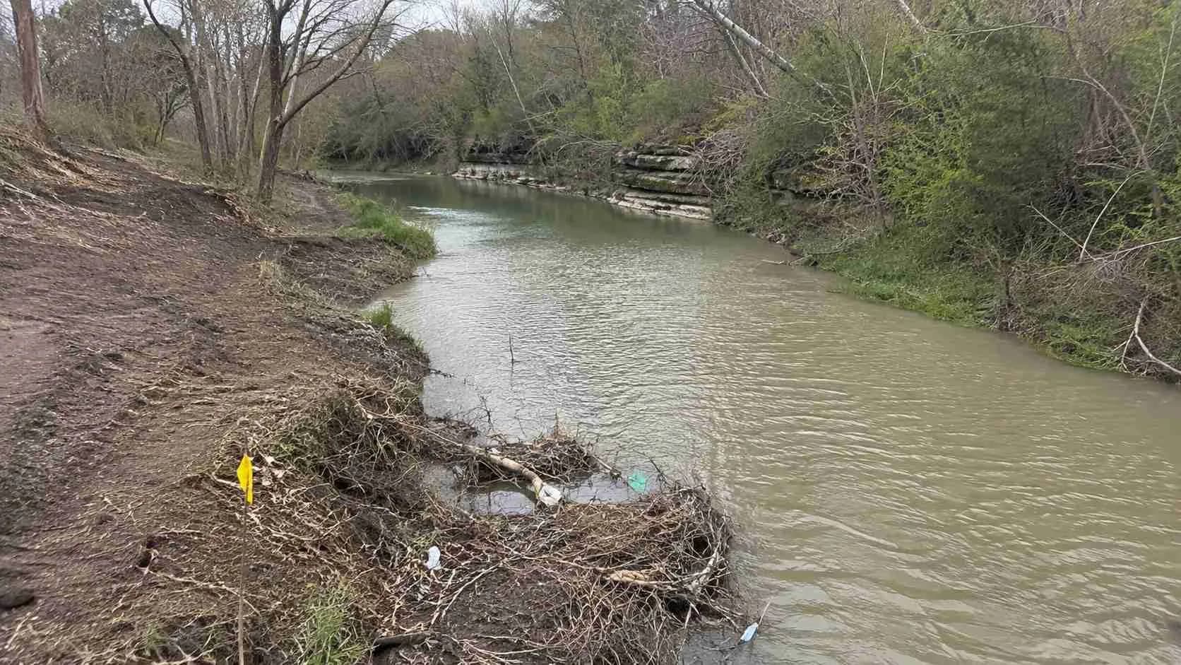 Engineer sampling a Texas creek before a discharge permit