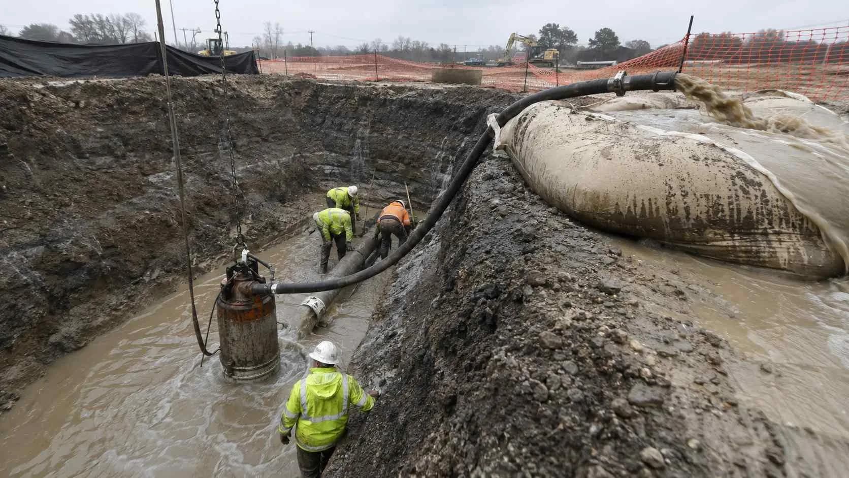 Active construction dewatering pump discharging sediment-laden groundwater at Texas excavation site.