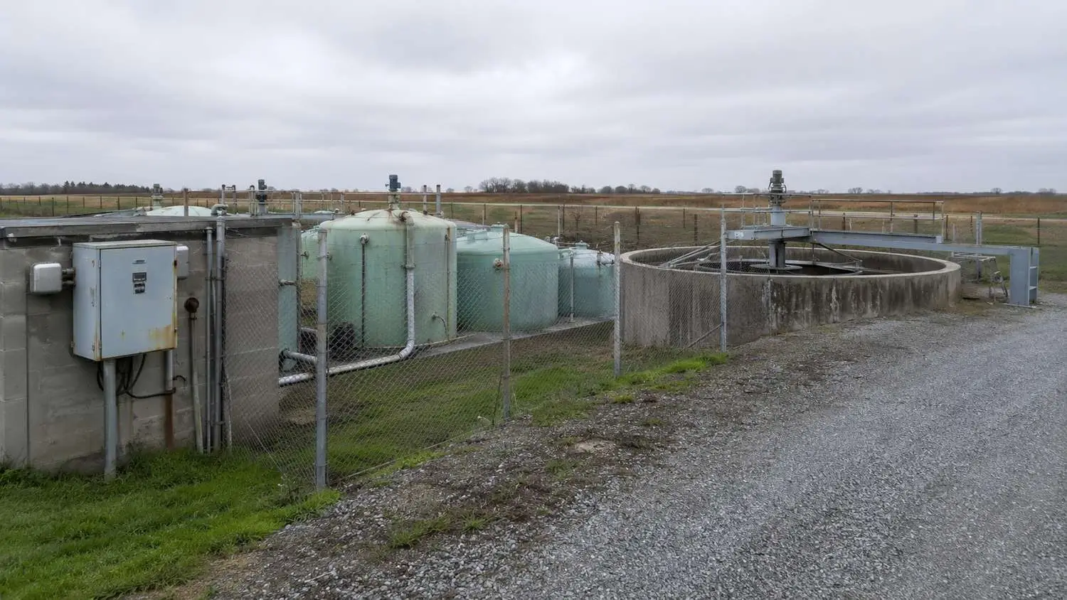 Small rural Colorado or Texas wastewater treatment plant showing aging infrastructure components including worn pump equipment and dated control systems that qualify for State Revolving Fund and USDA grant funding through a documented capital improvement plan