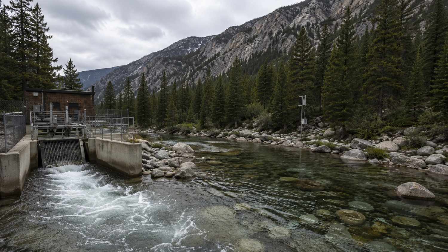 Treated wastewater outfall discharging to a Colorado mountain creek under a CDPS permit showing the receiving water context that drives effluent limit stringency evaluated by Modern Engineering Solutions.