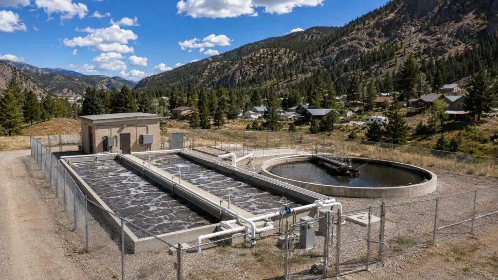 Aerial view of a Colorado rural package wastewater treatment plant with extended aeration tanks and clarifier serving a small mountain community evaluated by Modern Engineering Solutions.