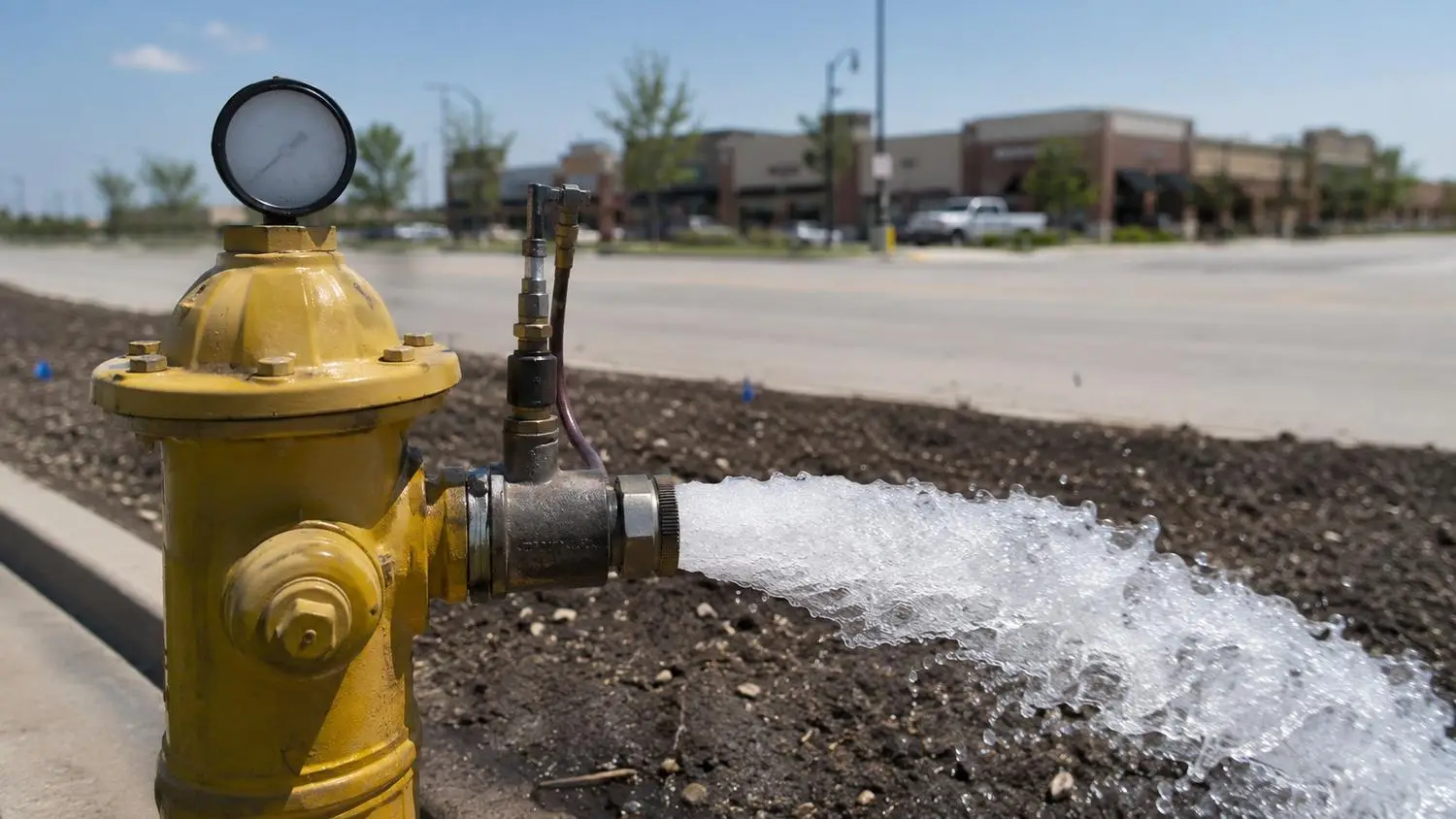 Fire hydrant flow test on Dallas area water main, representing MES fire flow analysis for developers.