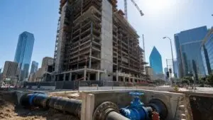 Dallas high rise tower under construction with water infrastructure, representing MES hydraulic modeling services.