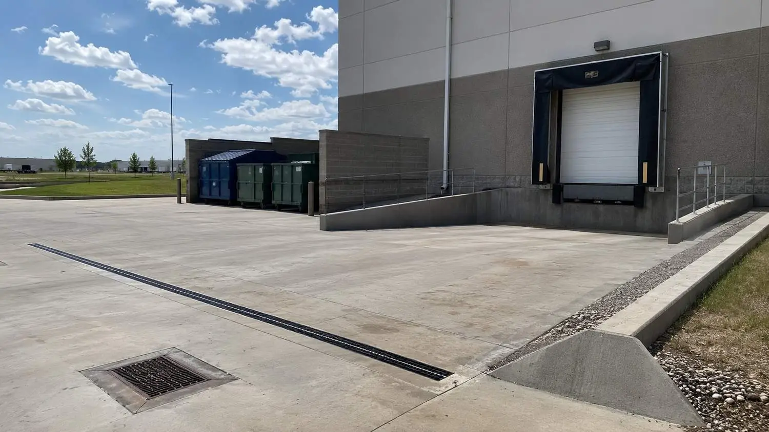 Outdoor loading dock and stormwater drainage at Dallas food manufacturing site, representing MES stormwater permit services.