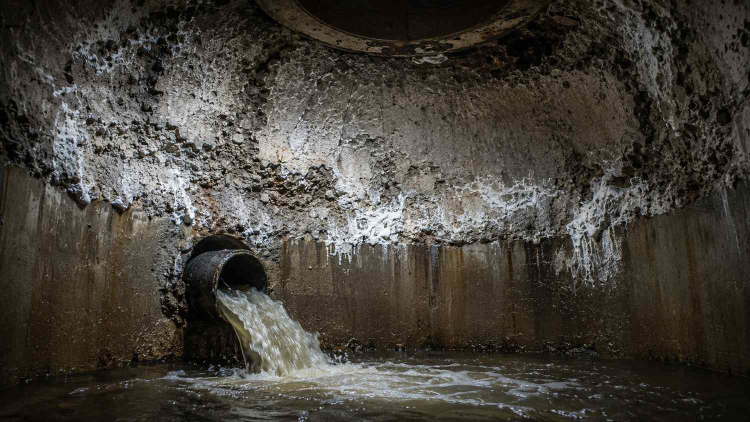 Severely corroded concrete receiving manhole crown showing hydrogen sulfide attack from Florida force main discharge point evaluated by Modern Engineering Solutions condition assessment.