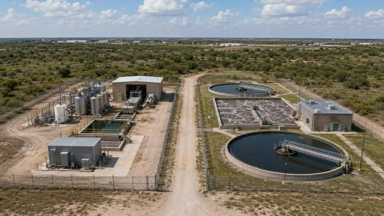 Ground-level wide shot of a Texas municipal wastewater treatment plant showing extended aeration basins with active biological treatment clarifiers and effluent monitoring equipment representing the domestic wastewater treatment infrastructure operating under municipal TPDES permit standards that Modern Engineering Solutions designs and permits for Texas municipalities and private treatment works operators