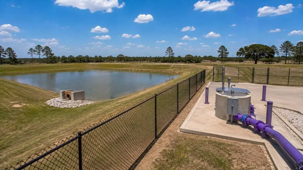 Detention pond and wastewater utility infrastructure on Harris County development site, representing MES combined site planning.