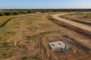 Empty Texas subdivision street with infrastructure installed but no homes started, representing MES permit timeline planning.